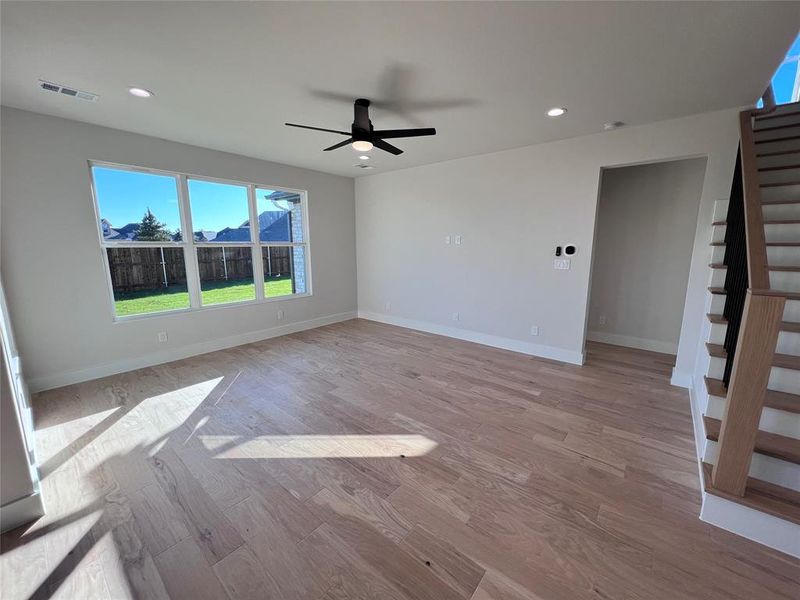 Living Room with wood stairs, natural light and wired for hanging tv