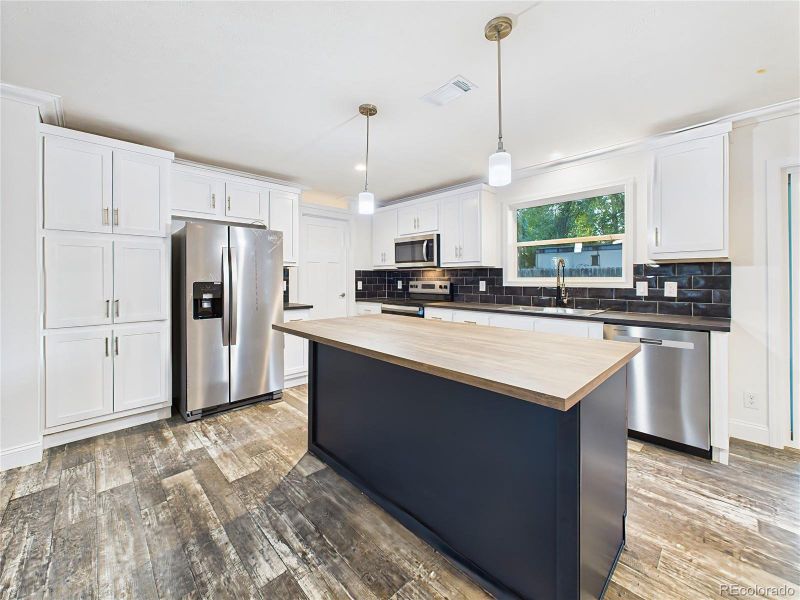 Window over the sink plus sliding doors provide extra light and access to the backyard.