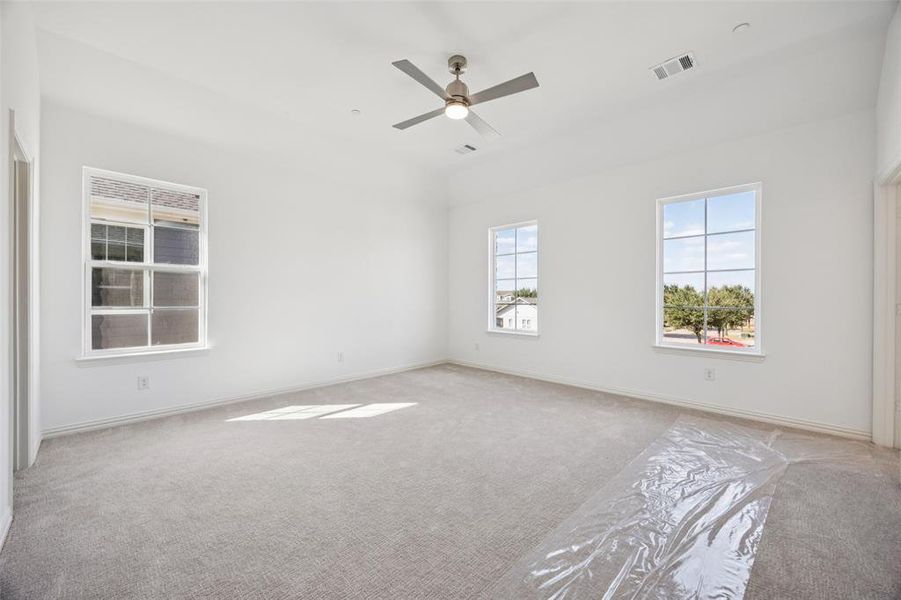 A spacious owner's suite that offers high ceilings, natural light from multiple windows, his & hers walk in closets....our Hansen floor plan has it all!