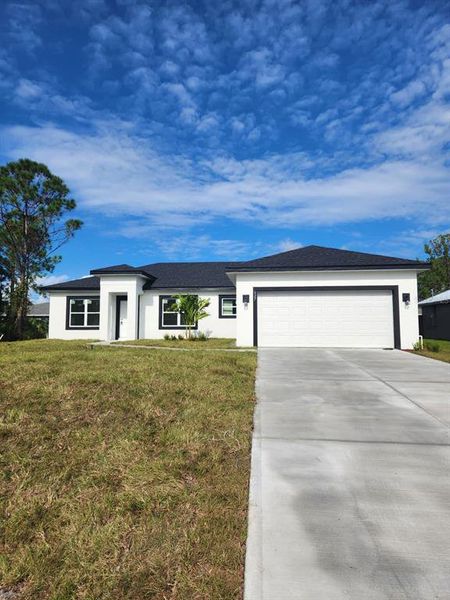 Front exterior of a new home in , Palm Bay, FL, highlighting curb appeal (Image 25). Front exterior of a new home in , Palm Bay, FL, highlighting curb appeal (Image 25).