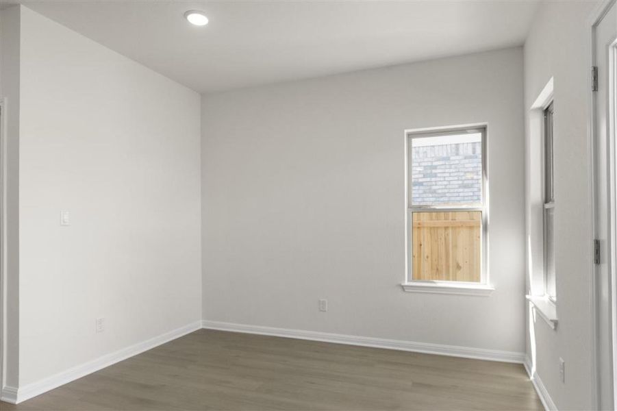Unfurnished room with recessed lighting, wood finished floors, and baseboards