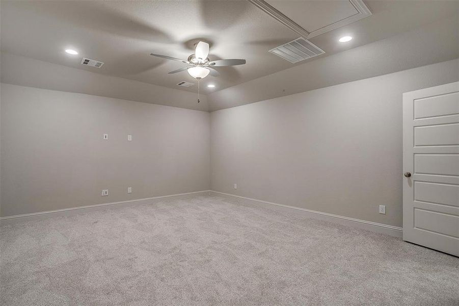 Carpeted spare room with ceiling fan