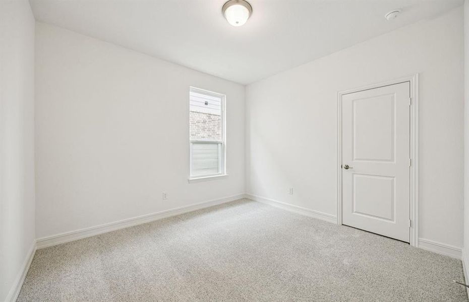 Roomy secondary bedroom with extensive closet storage *Real home pictured