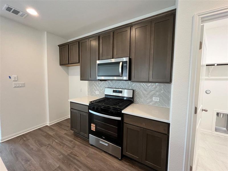 For demonstration purposes only. Same floorplan as 5331 Bruno. Whirlpool vented microwave, gas range and dishwasher