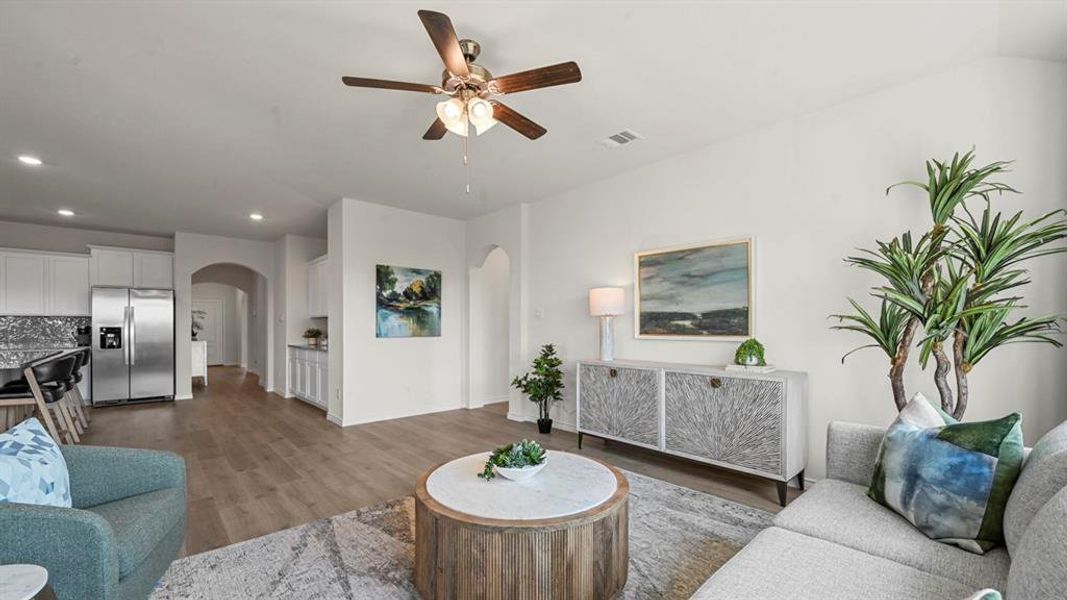 Living area with recessed lighting, dark wood-style floors, a ceiling fan, and arched walkways
