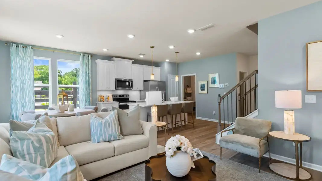 Open concept kitchen and family room in new construction townhome with seamless flow and natural light. Open concept kitchen and family room in new construction townhome with seamless flow and natural light.