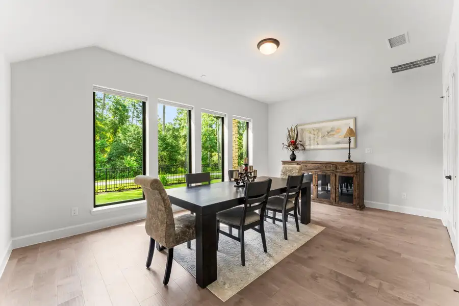 The large windows bring in a lot of natural light and frame the view of the trees and fenced-in yard. The wall of windows brings the outdoors in! The large windows bring in a lot of natural light and frame the view of the trees and fenced-in yard. The wall of windows brings the outdoors in!