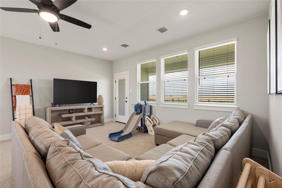 Well-lit and inviting, this recreation room offers comfortable seating and ample natural light from its multiple windows. Well-lit and inviting, this recreation room offers comfortable seating and ample natural light from its multiple windows.