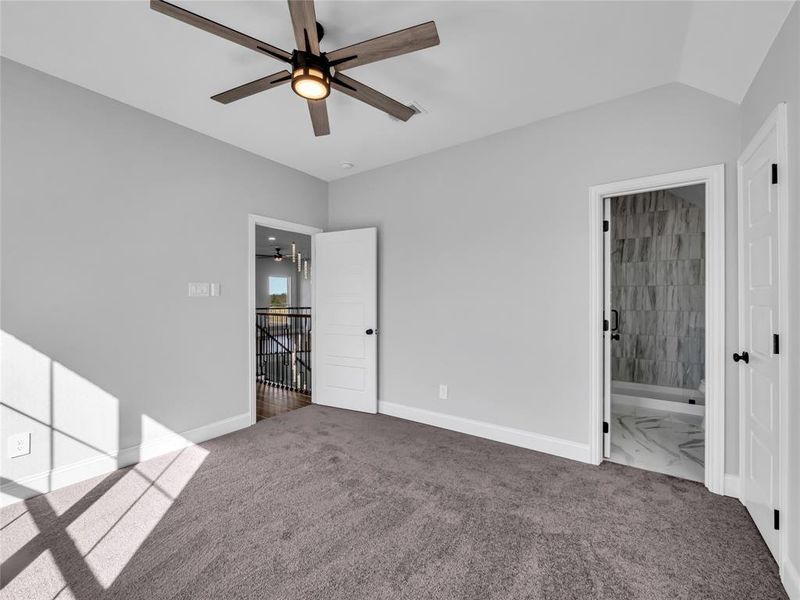 Bedroom upstairs with carpet and ceiling fan and connected bathroom Bedroom upstairs with carpet and ceiling fan and connected bathroom