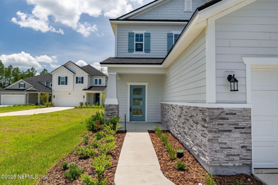Front exterior of a new home in Beacon Lake, St. Augustine, FL, highlighting curb appeal (Image 37).