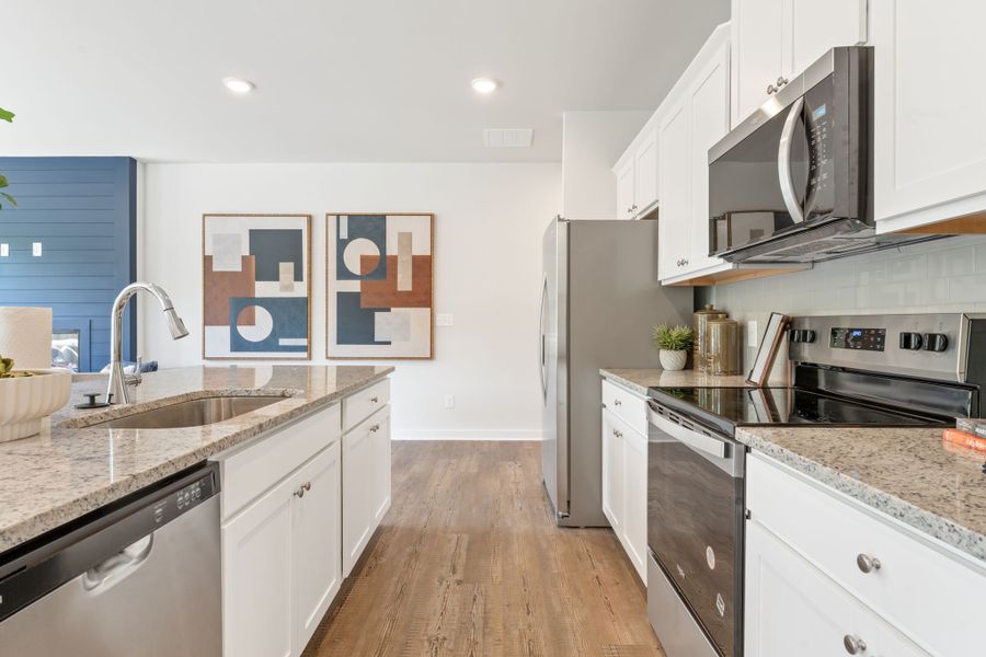 A kitchen with white cabinets.
