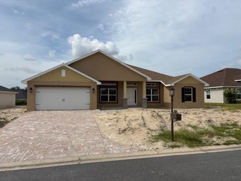 Front exterior of a new home in Juliette Falls, Dunnellon, FL, highlighting curb appeal (Image 6).