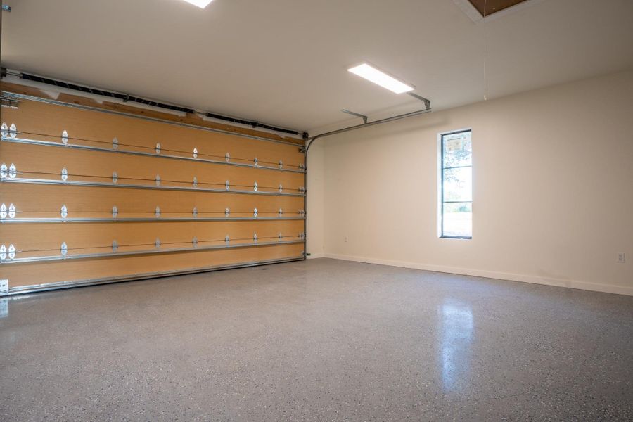 Garage featuring baseboards
