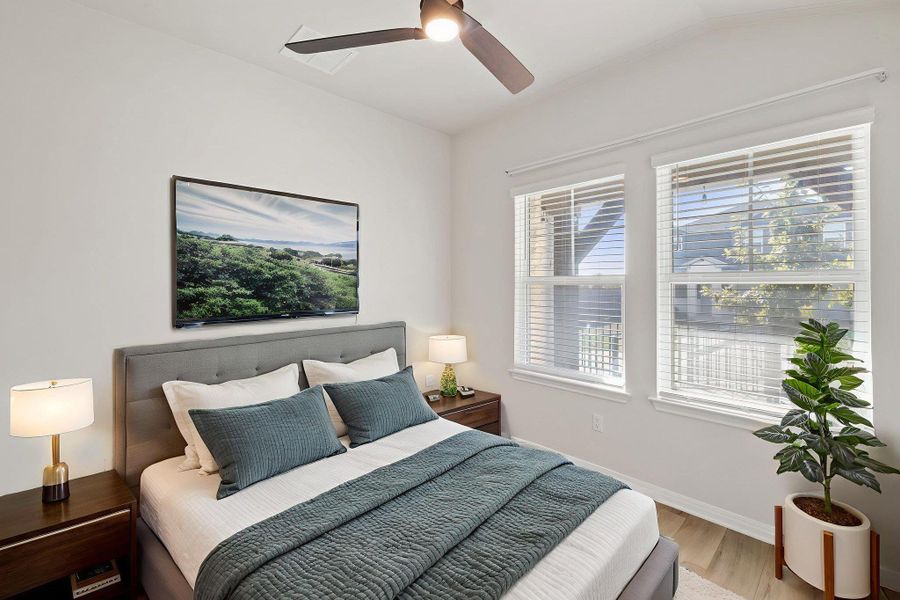 Bedroom with a ceiling fan and wood finished floors Bedroom with a ceiling fan and wood finished floors