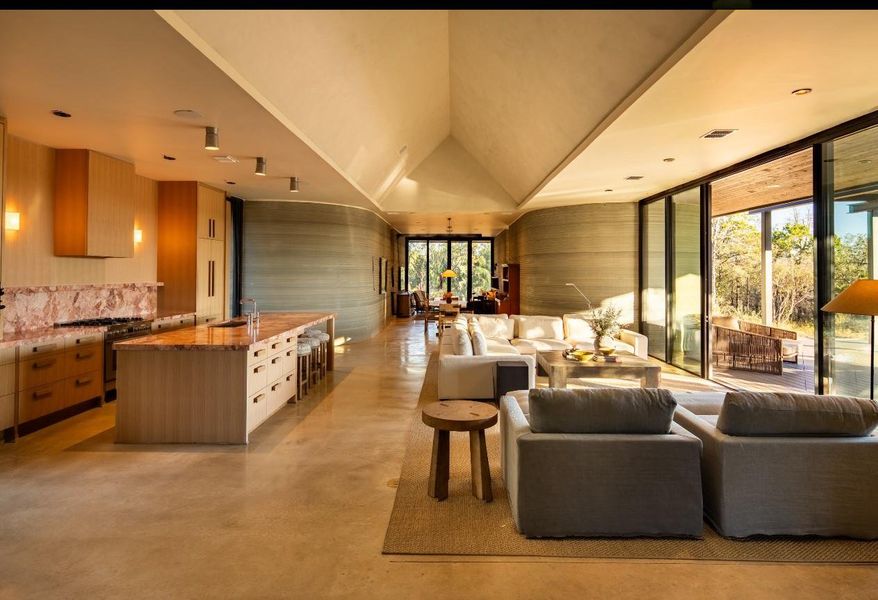 Living area featuring concrete flooring and floor to ceiling windows
