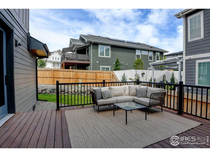 Spacious back deck off of the kitchen with access to garage.