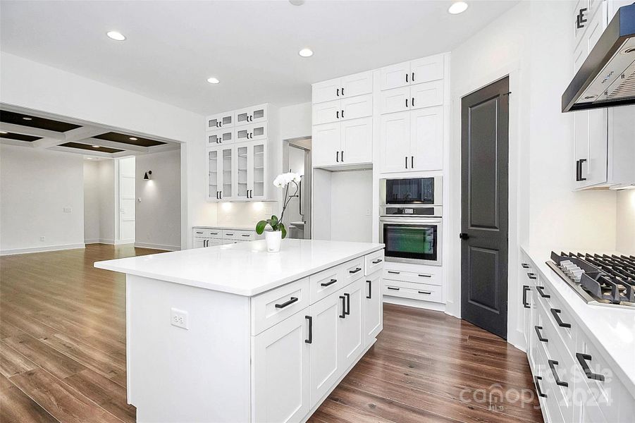 Great room with gas fireplace & coffered ceiling.