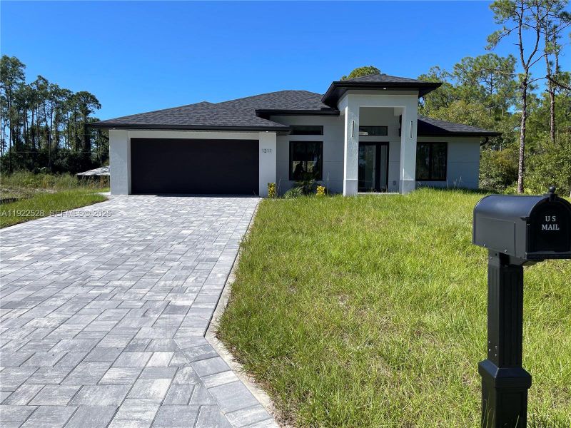 Front exterior of a new home in , Lehigh Acres, FL, highlighting curb appeal (Image 19). Front exterior of a new home in , Lehigh Acres, FL, highlighting curb appeal (Image 19).