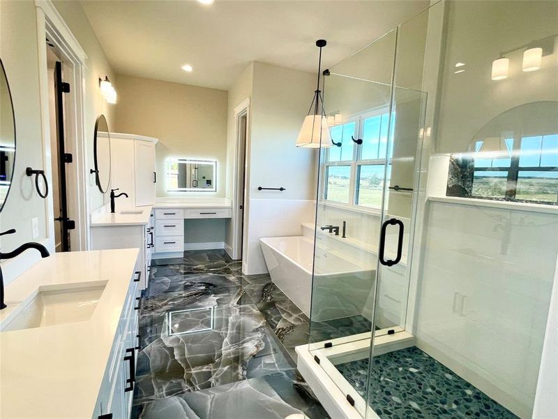 Master bath features dual sinks and sit down make up vanity