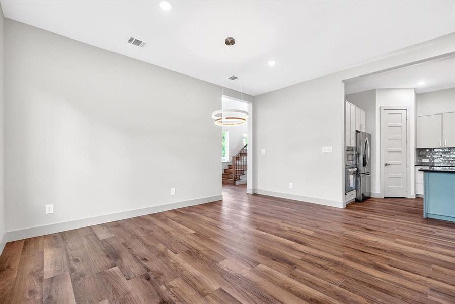 Unfurnished living room with dark wood-type flooring and recessed lighting Unfurnished living room with dark wood-type flooring and recessed lighting