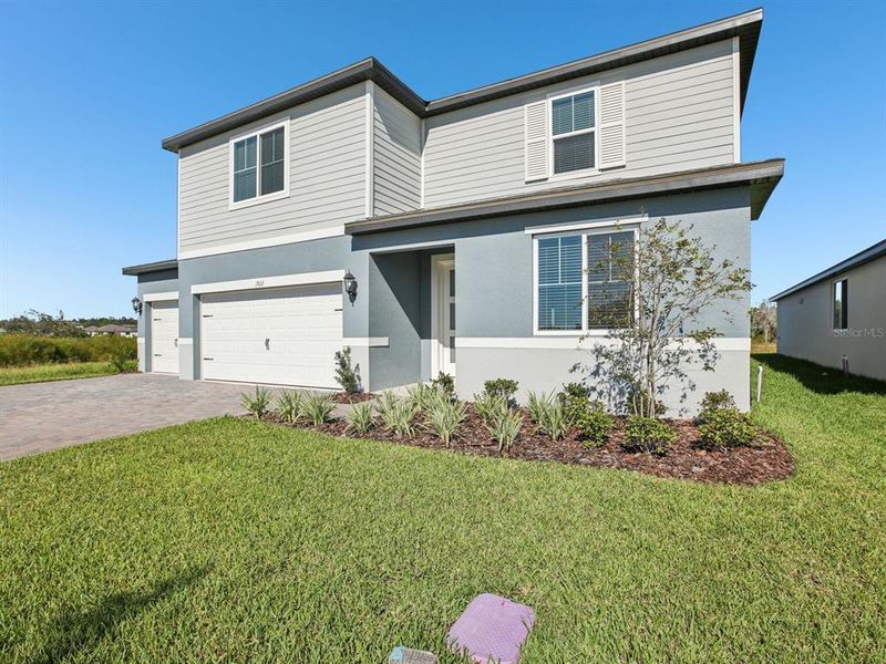 Front exterior of a new home in Two Rivers - Signature Series, Zephyrhills, FL, highlighting curb appeal (Image 2).