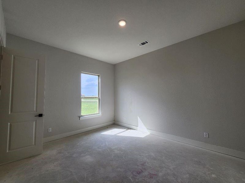 Interior room featuring a single window, recessed lighting, and a paneled door with dark hardware
