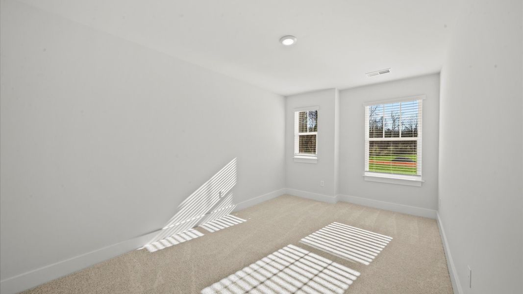 First-rate secondary bedroom with a spacious walk-in closet and elegant carpeted flooring