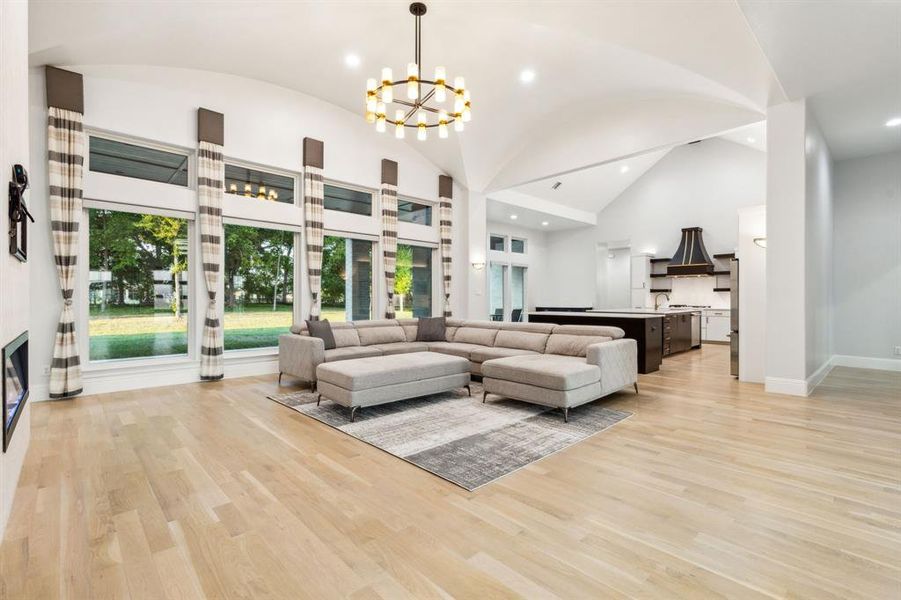 Family room with wall of windows overlooking yard and trees