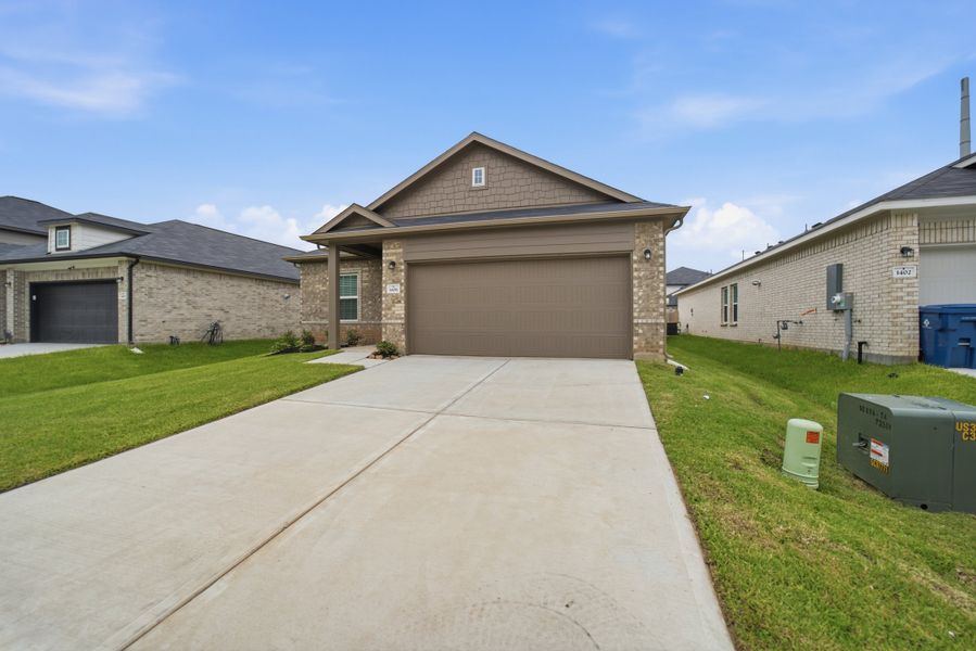 Front exterior of a new home in Steed Landing, Texas City, TX, highlighting curb appeal (Image 2).