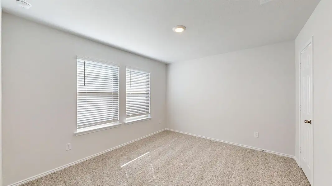 Unfurnished room with light carpet and baseboards