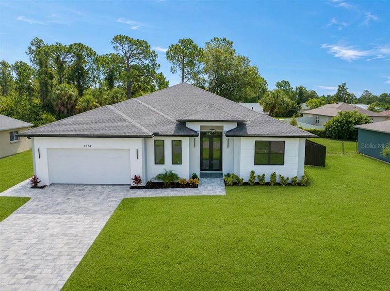 Front exterior of a new home in , North Port, FL, highlighting curb appeal (Image 1). Front exterior of a new home in , North Port, FL, highlighting curb appeal (Image 1).