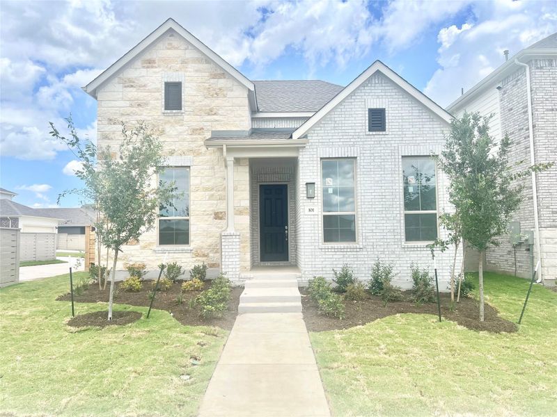 View of front of home with a front lawn, stone siding, and a shingled roof View of front of home with a front lawn, stone siding, and a shingled roof
