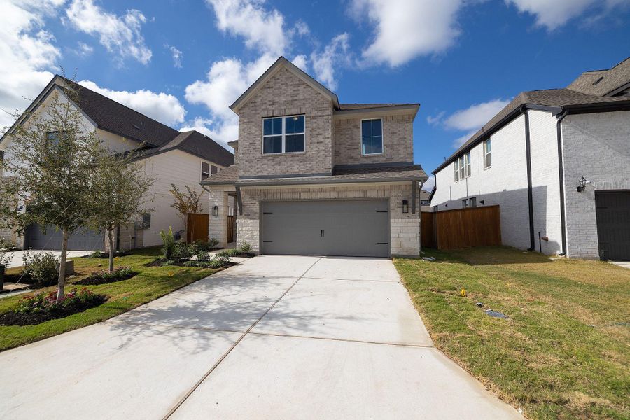 Front exterior of a new home in Parmer Ranch, Georgetown, TX, highlighting curb appeal (Image 19). Front exterior of a new home in Parmer Ranch, Georgetown, TX, highlighting curb appeal (Image 19).