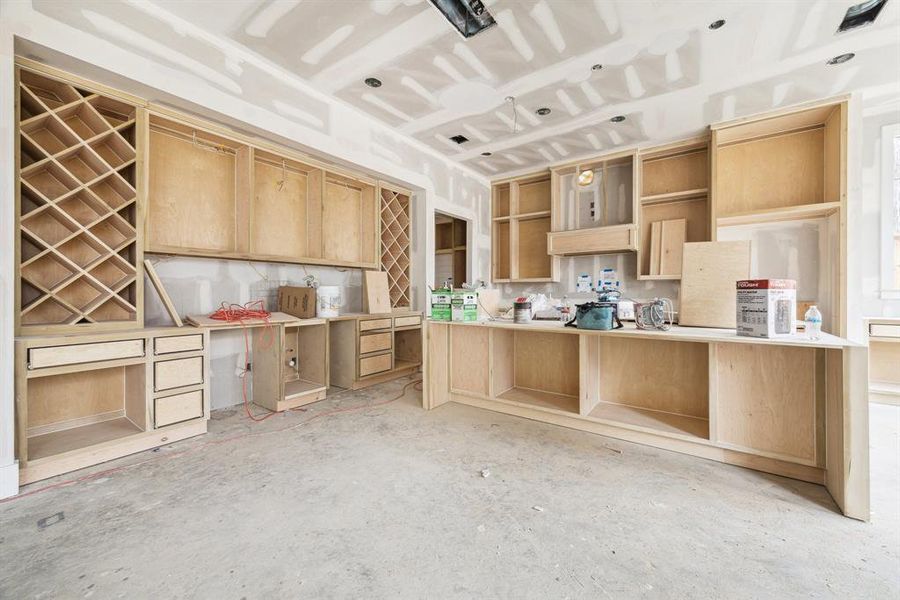 Fantastic Wet-Bar with Sink, Wine Chiller and Ice Maker.  There is all Wine Storage, Storage Drawers, Upper Cabinets with Glass Fronts and more.... Construction as of Jan. 13th, 2025.