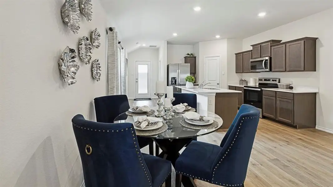 Dining space with light wood-style flooring and recessed lighting Dining space with light wood-style flooring and recessed lighting