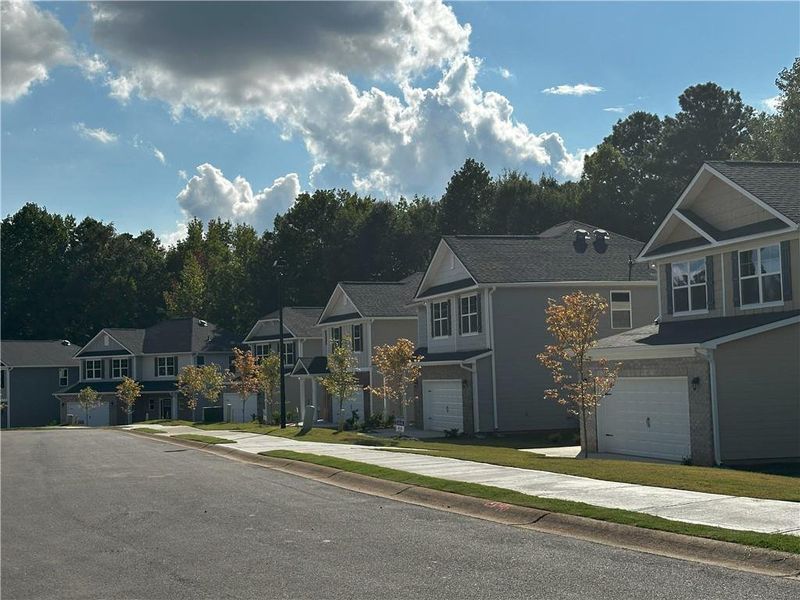 Front exterior of a new home in Canterbury Villas, Carrollton, GA, highlighting curb appeal (Image 1).