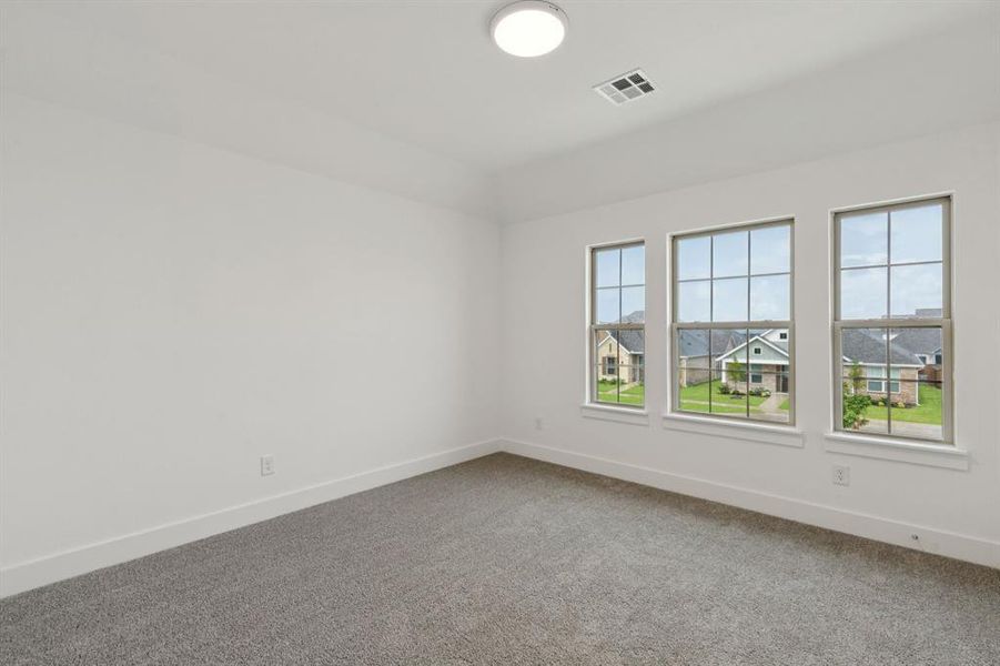 Carpeted empty room with baseboards Carpeted empty room with baseboards