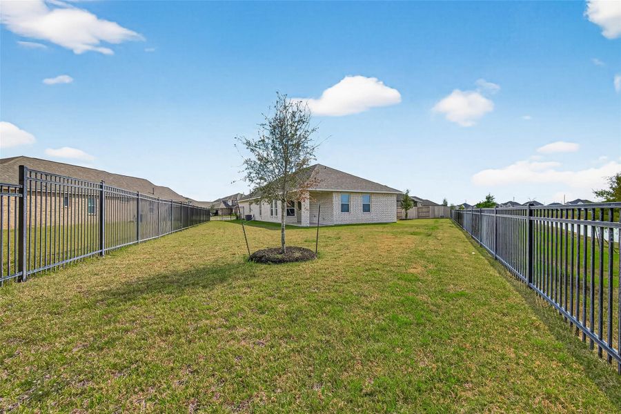 Exterior details and patio area of a home in Sunterra, Katy (Image 30).
