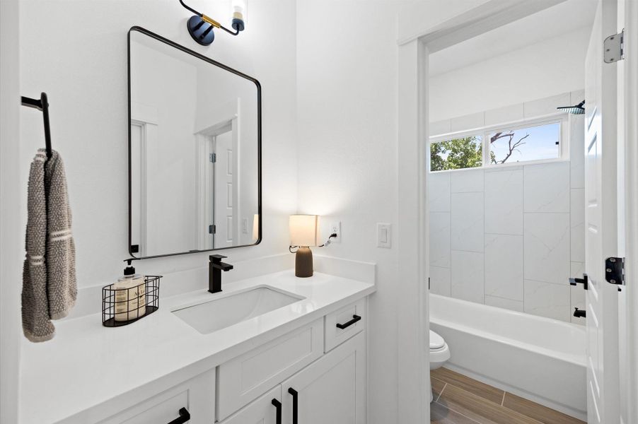 A Jack and Jill secondary bathroom designed for shared convenience, featuring a bathtub and shower combo. The space is thoughtfully laid out with dual entrances, allowing for easy access while maintaining privacy. A Jack and Jill secondary bathroom designed for shared convenience, featuring a bathtub and shower combo. The space is thoughtfully laid out with dual entrances, allowing for easy access while maintaining privacy.