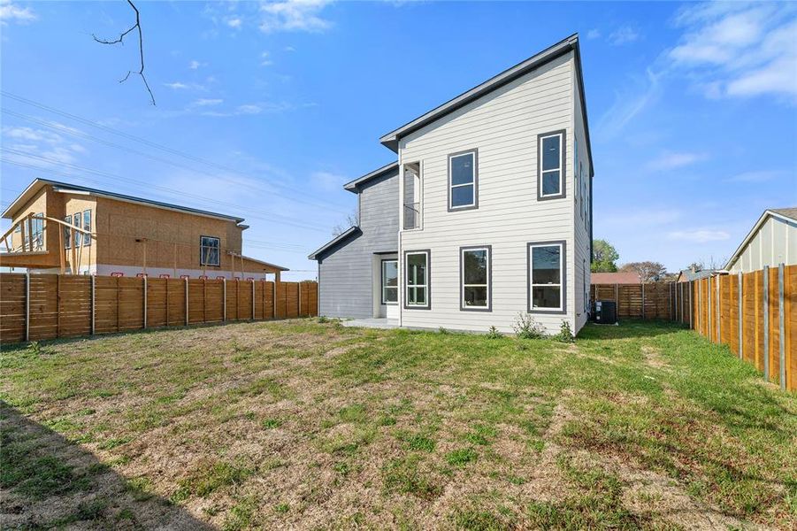 Rear view of property featuring a fenced backyard