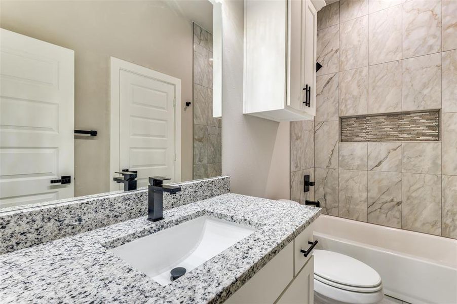 Bathroom featuring vanity and  shower combination