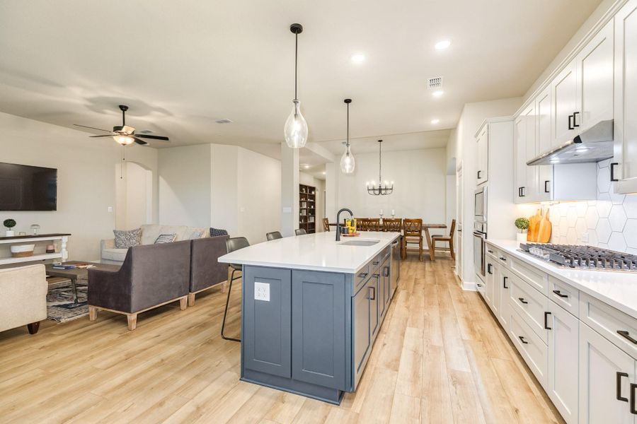 This grand oversized island is very functional with lots of storage, counter space, and a deep sink. The island has electrical outlets on three sides to conveniently power any appliances or devices, as you enjoy the space