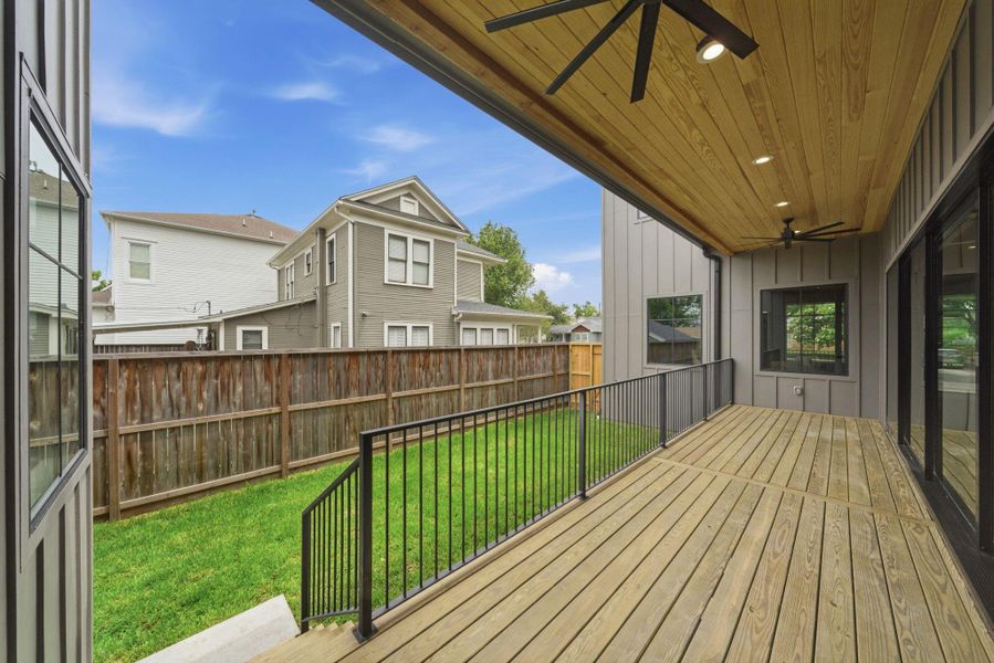Wide patio overlooking the green space. Well suited for outdoor dining.
