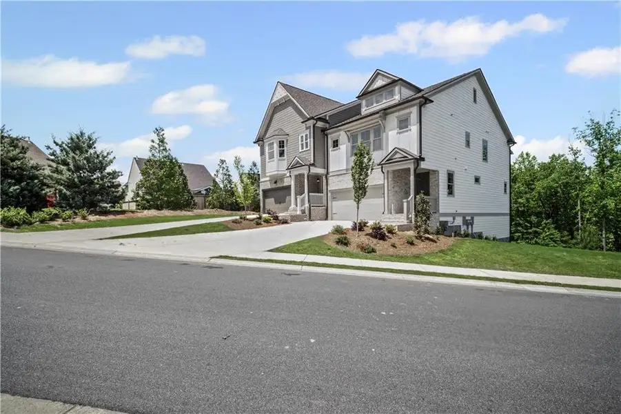 Front exterior of a new home in The Retreat at River Green, Canton, GA, highlighting curb appeal (Image 22).