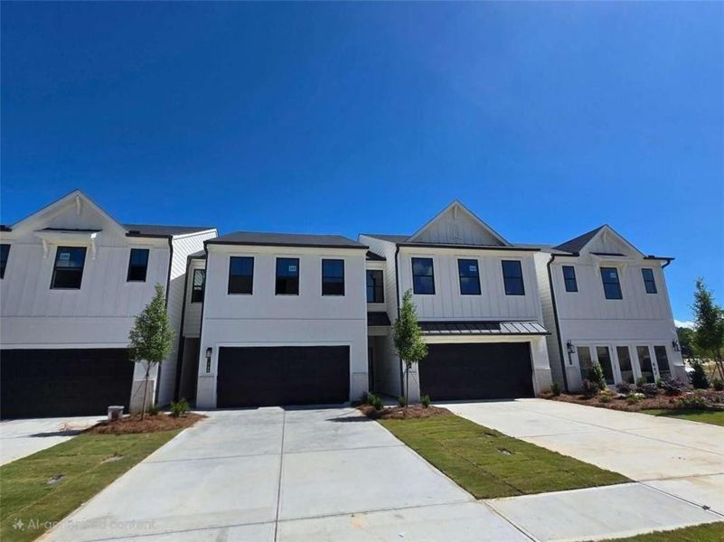 Front exterior of a new home in Sherwood Square, Flowery Branch, GA, highlighting curb appeal (Image 8). Front exterior of a new home in Sherwood Square, Flowery Branch, GA, highlighting curb appeal (Image 8).