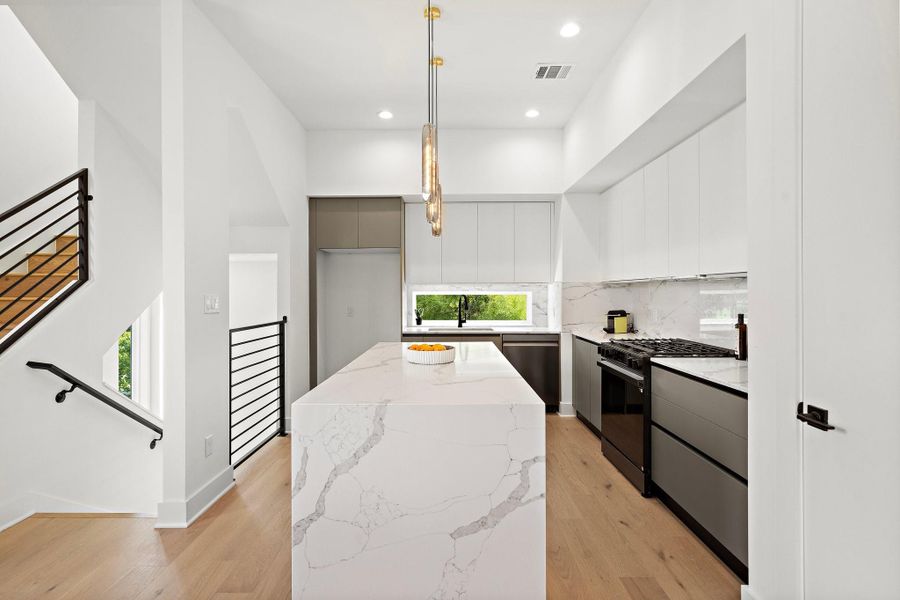 This elegant kitchen features sophisticated European-style cabinets with soft close drawers sleek, minimalist lines paired with stunning quartz countertops for a modern luxury and timeless appeal**Images shown are from a similar model. Actual features may vary. This elegant kitchen features sophisticated European-style cabinets with soft close drawers sleek, minimalist lines paired with stunning quartz countertops for a modern luxury and timeless appeal**Images shown are from a similar model. Actual features may vary.