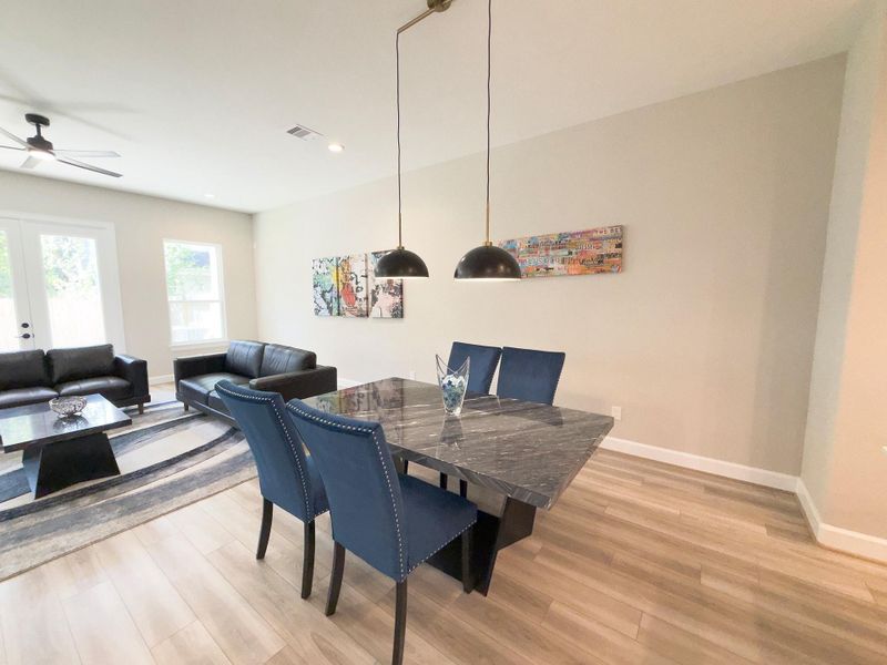 The ROCburne’s dining area blends seamlessly with the open floor plan, offering a bright, inviting space perfect for both intimate dinners and lively gatherings. Image depicts home as-is.