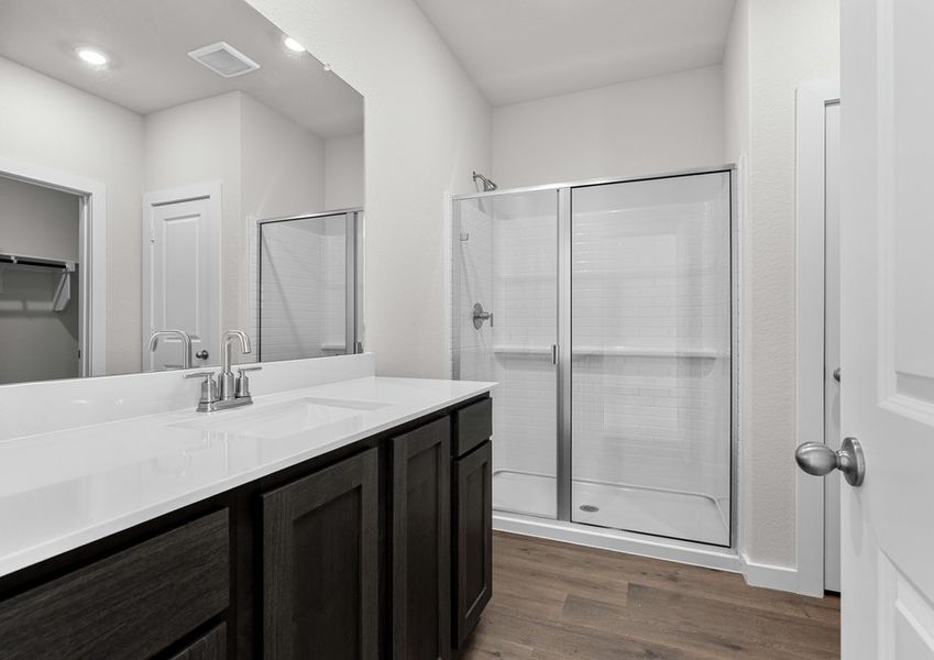The master bathroom has a glass, walk-in shower.