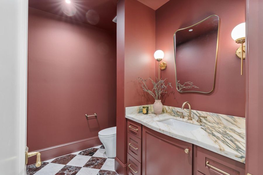Custom touches abound in this home, the powder bath downstairs is no exception to the common trait throughout