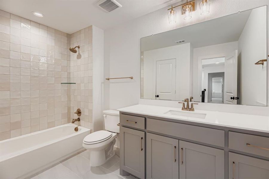 Bathroom with  shower combination, vanity, light tile patterned floors, and recessed lighting